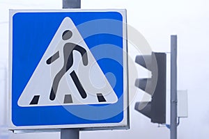 Pedestrian crossing sign on the road. Traffic lights and other road signs. Traffic regulation