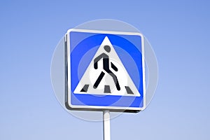 A pedestrian crossing sign. Sign on a blue sky background.