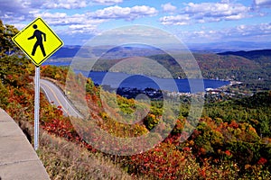 Pedestrian Crossing Sign at Top of Autumn Mountain with Lake