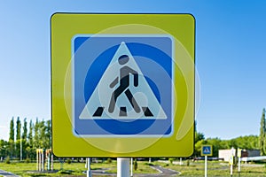 Pedestrian crossing sign with yellow reflector