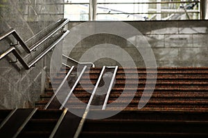 Pedestrian crossing staircase. Two handrails for wheelchairs. Metal railings for bicycles, wheelchairs and strollers