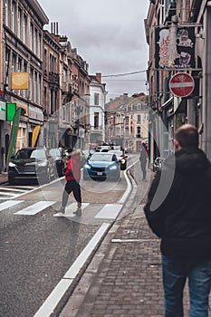 Pedestrian Crossing a Street in Historic Dinant, Belgium