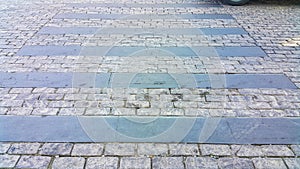 Pedestrian crosswalk made of stones. Cobblestone walkway. Crosswalk on the road for safety when people walking cross the street