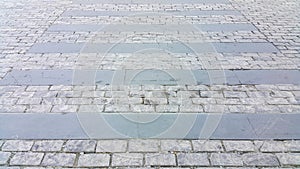 Pedestrian crosswalk made of stones. Cobblestone walkway. Crosswalk on the road for safety when people walking cross the street