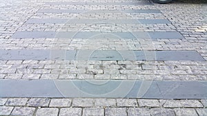 Pedestrian crosswalk made of stones. Cobblestone walkway. Crosswalk on the road for safety when people walking cross the street