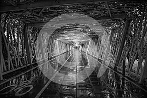 Pedestrian and cycling tunnel after rainfall in black and white