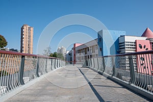 A pedestrian overpass composed of stone slabs and guardrails