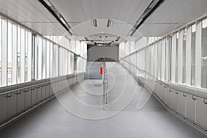 Pedestrian pathway or corridor or hallway between train station and building