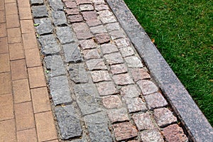 A pedestrian pavement made of stone and granite tiles.