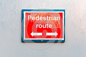 Pedestrian route direction red painted notice board