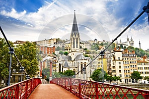 Pedestrian Saint Georges footbridge and the Saint Georges church in Lyon, France