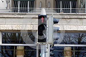 Pedestrian traffic light is on red, close up, by day, without people
