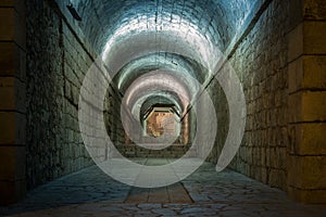 Pedestrian tunnel illuminated by white lamp photo