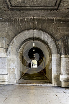 Pedestrian tunnel in Pont du Carrousel bridge at Seine river promenade in Paris city centre