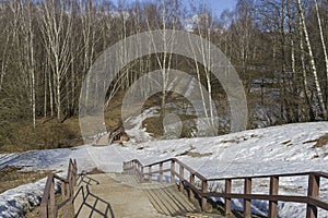 Pedestrian walkway with foresters and a bridge crossing a small ravine