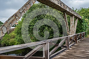 Pedestrian wooden bridge and stone bridge over the PÃªra stream, PedrogÃ£o Grande PORTUGAL photo