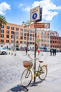 Pedestrian zone street sign with a retro styled female bicycle parked under. Walking aria in Rome city center.