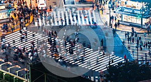 Pedestrians cross the Shibuya Scramble crosswalk, in Tokyo, Japan