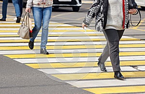 Pedestrians cross the street at a pedestrian crossing