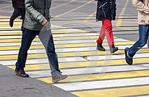 Pedestrians cross the street at a pedestrian crossing