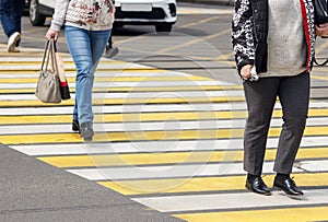 Pedestrians cross the street at a pedestrian crossing