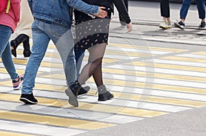 Pedestrians cross the street at a pedestrian crossing