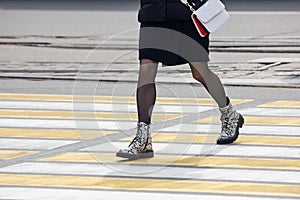 Pedestrians cross the street at a pedestrian crossing