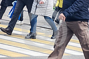 Pedestrians cross the street at a pedestrian crossing