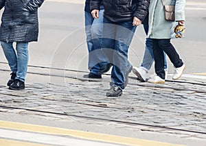 Pedestrians cross the street at a pedestrian crossing