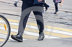 Pedestrians cross the street at a pedestrian crossing