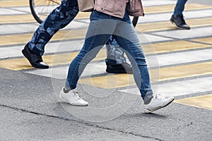 Pedestrians cross the street at a pedestrian crossing