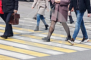 Pedestrians cross the street at a pedestrian crossing