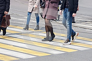 Pedestrians cross the street at a pedestrian crossing