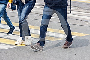 Pedestrians cross the street at a pedestrian crossing