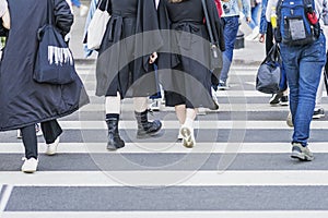 Pedestrians crossing crosswalk. Young people in black clothes, Stylish hipster girls walking city on weekend day