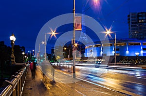 Pedestrians crossing Princes Bridge in Melbourne at night