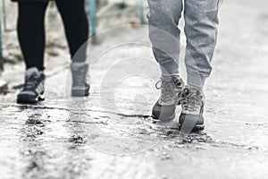 Pedestrians glide along the icy sidewalk. Winter ice on footpaths photo
