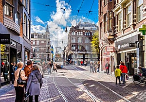 Pedestrians and Trams on the busy Leidsestraat in the center of Amsterdam