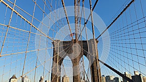 Pedestrians walk over the Brooklyn Bridge. Crowd of people on Brooklyn Bridge.