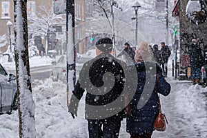 Pedestrians walking on Mont-Royal Avenue during snow storm