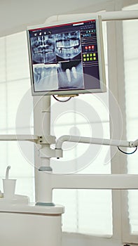 Pediatric dentist showing on monitor teeth x-ray