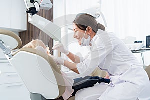 A pediatric dentistry examining the teeth of her patient. Dentist office