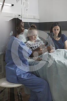 Pediatric healthcare facility staff analyzing MRI results of ill kid under treatment