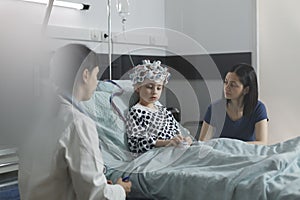 Pediatric hospital ward neurology specialist examining hospitalized girl brain condition