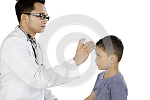 Pediatrician checking temperature his patient