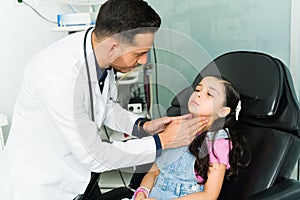 Pediatrician checking the tonsils of a patient
