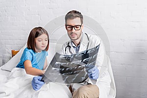 pediatrician and child looking at x photo