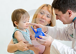 Pediatrician counseling mother and son about nasal irrigatio