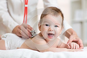 Pediatrician doctor examines baby with stethoscope