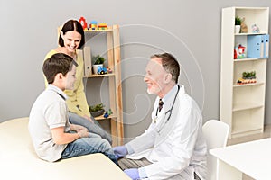 Pediatrician doctor examining child photo